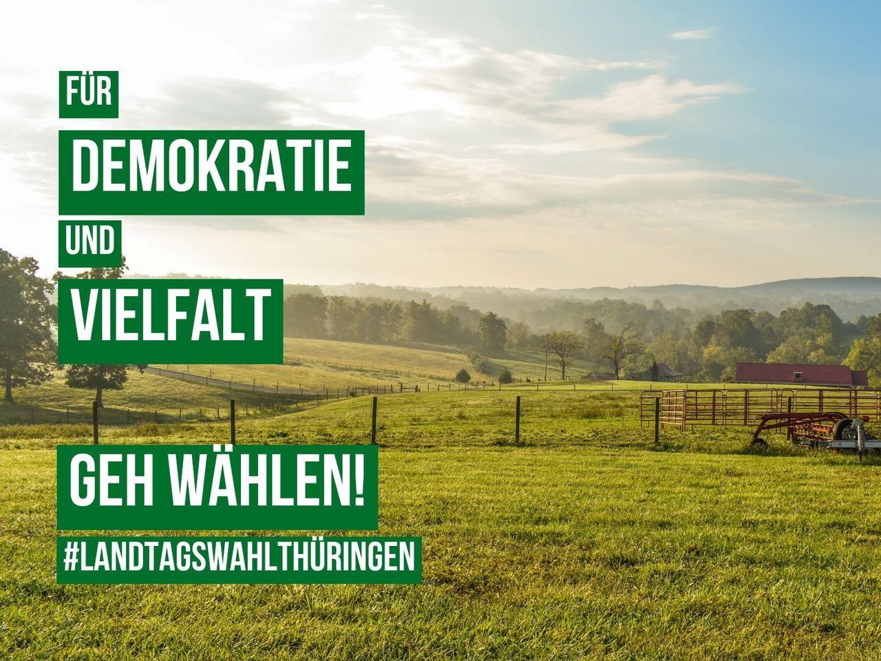 Eine Agrarlandwirtschaft in Thüringen. Man sieht über eine Wiese und über Zäune in die Weite. Im Hintergrund Wald und Berge. 